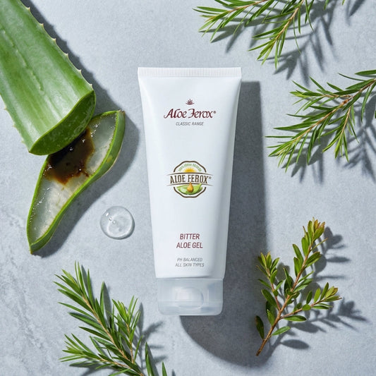 Aloe Ferox Bitter Aloe Gel tube with aloe vera leaf and leaves on a light gray background