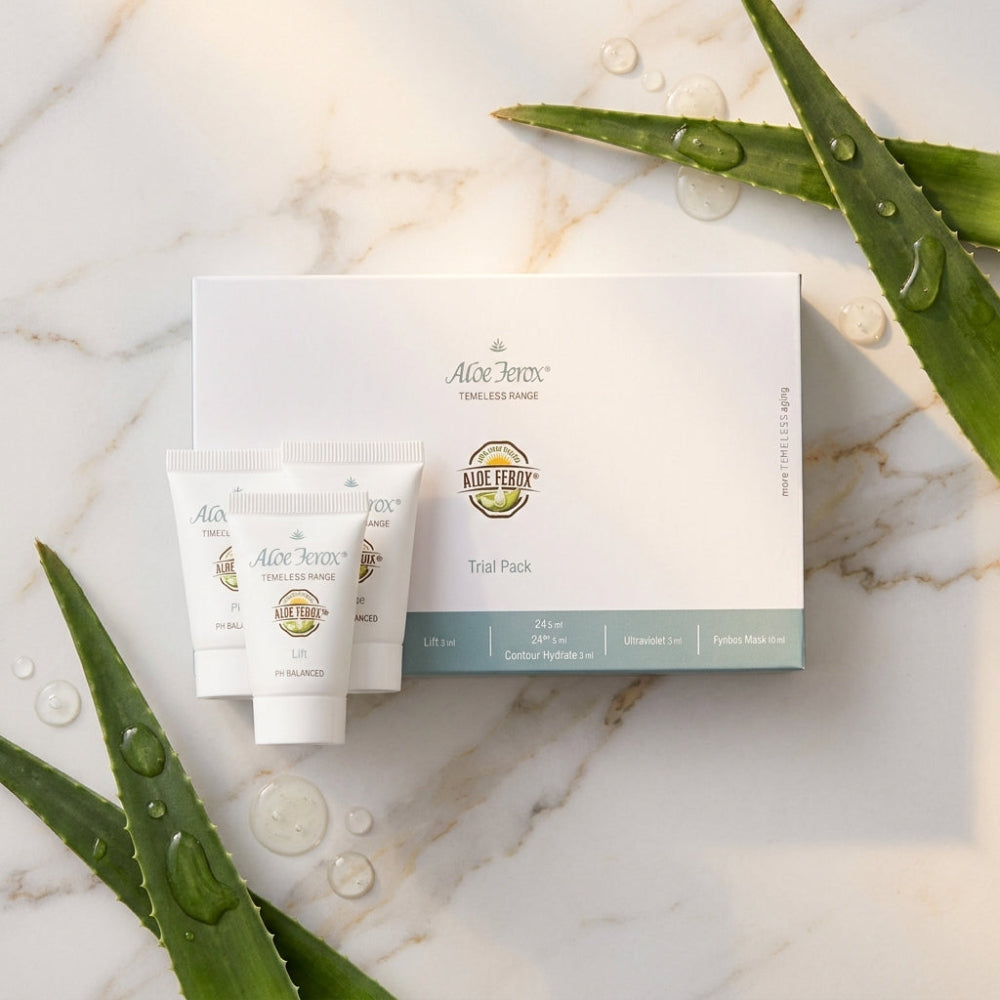 Aloe ferox Timeless trial pack skincare products and packaging on a marble surface with aloe leaves.
