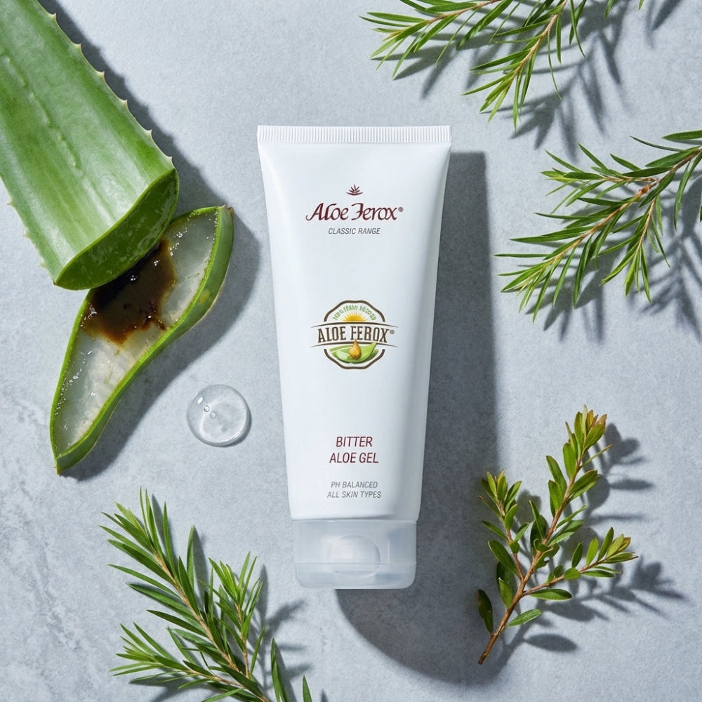 Aloe Ferox Bitter Aloe Gel tube with aloe vera leaf and leaves on a light gray background