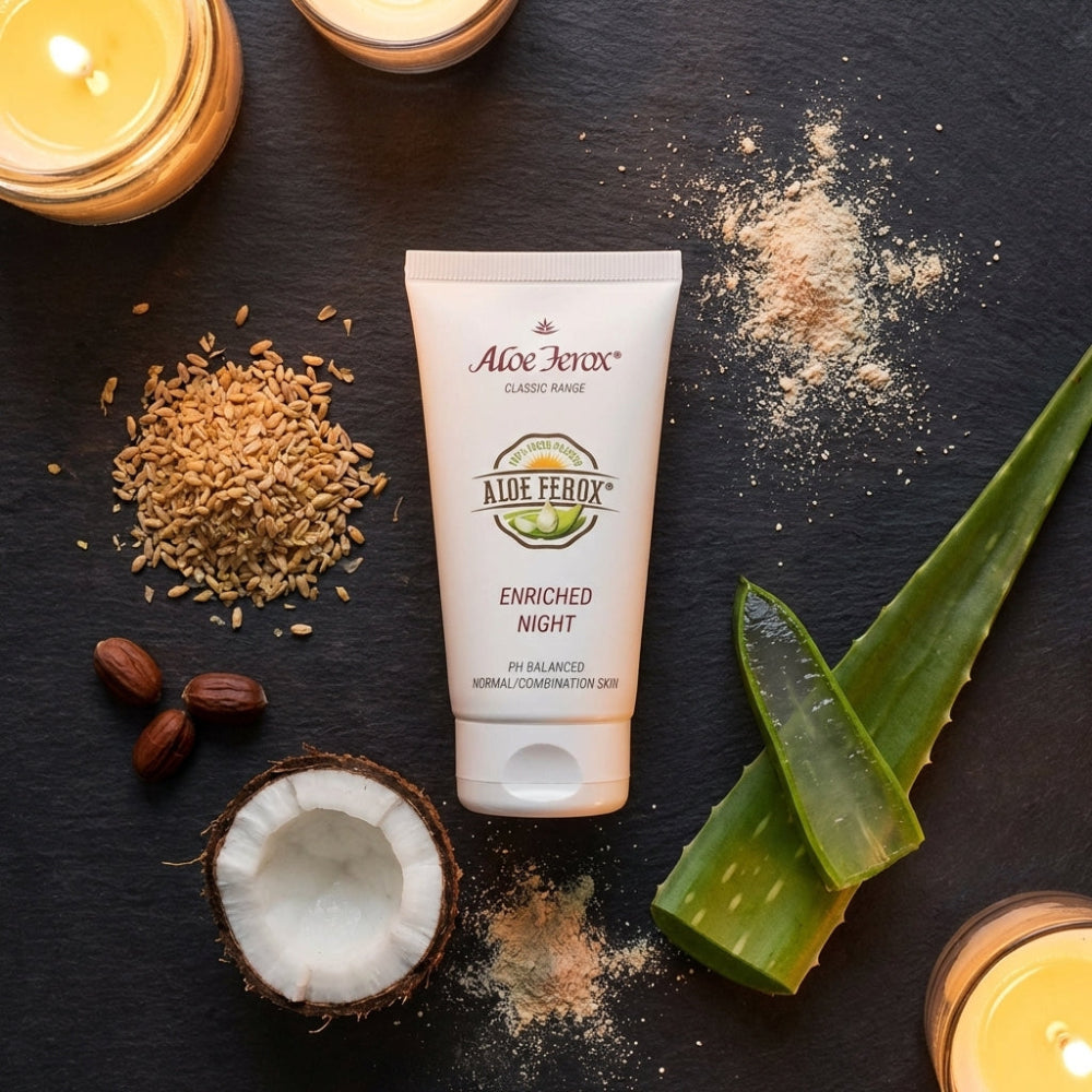 Aloe ferox enriched night cream surrounded by aloe leaves, coconut on a dark surface