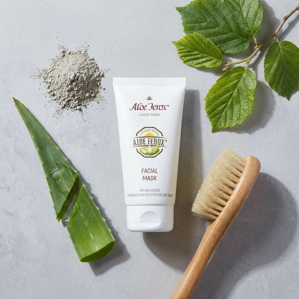 Aloe Ferox facial mask tube with aloe vera leaves, brush, and powder on a light background