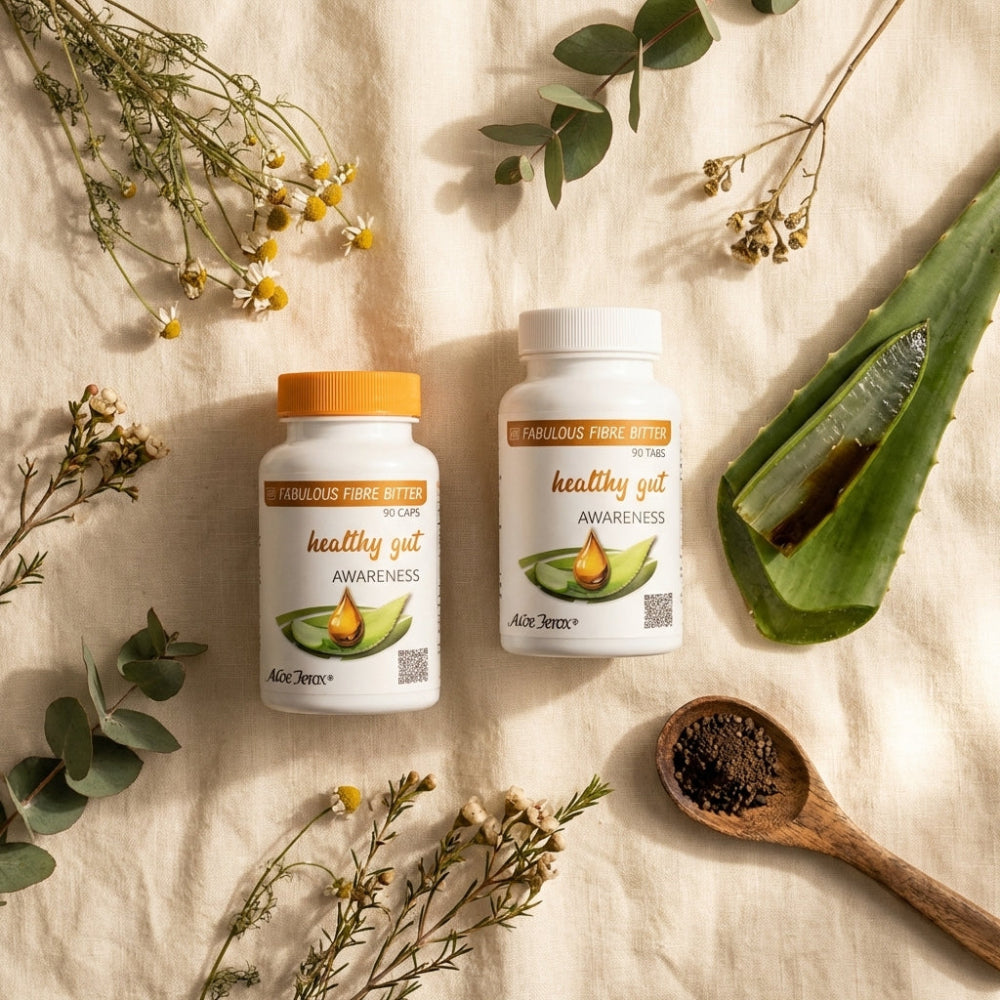 Two bottles of 'Healthy Gut Awareness' on a natural background with herbs and a wooden spoon.