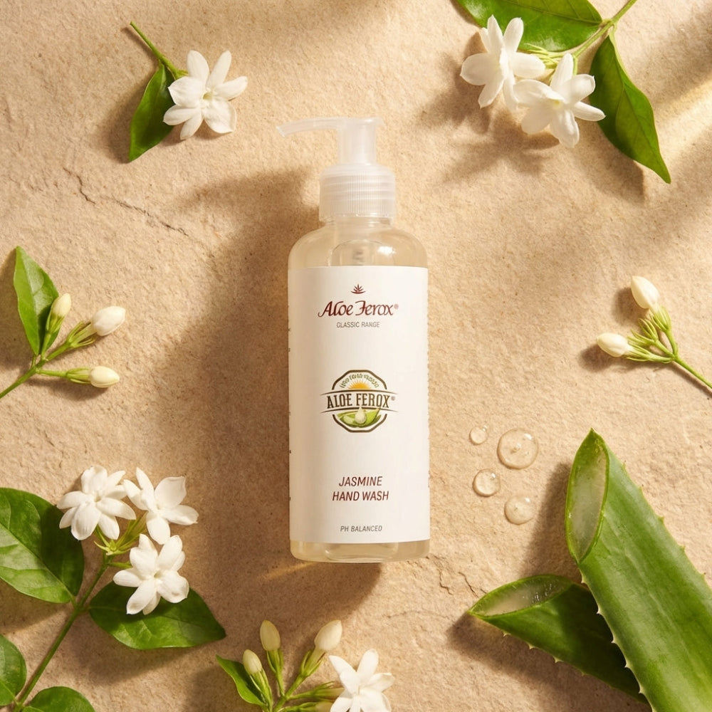 Aloe Ferox Jasmine Hand Wash bottle on a beige background with flowers and leaves.