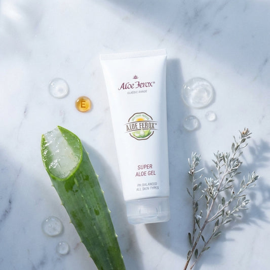 Aloe Ferox Super Aloe Gel tube with aloe ferox leaf and plant on marble background