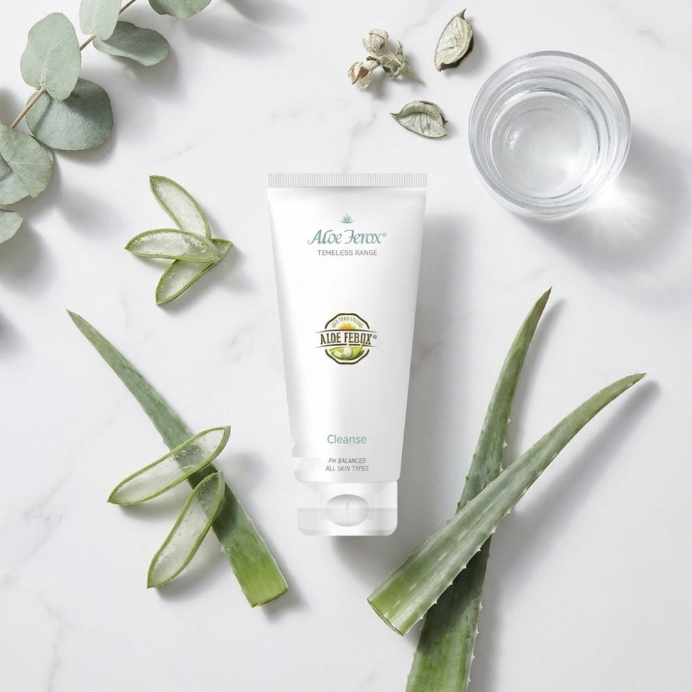 Aloe ferox product with fresh aloe leaves and water on a light background