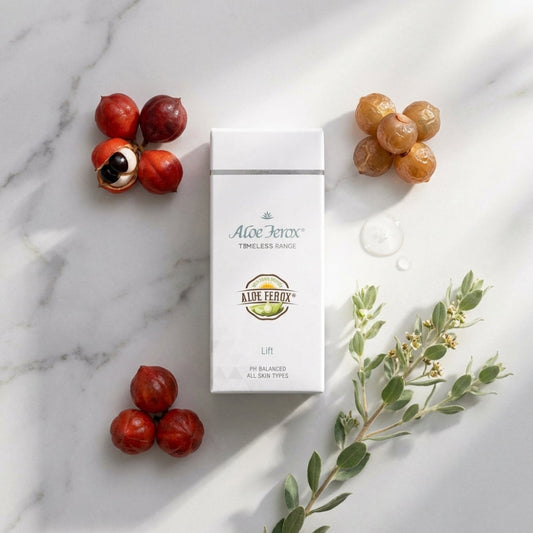 Aloe Ferox lift skincare product packaging on a marble surface with fruits and leaves.