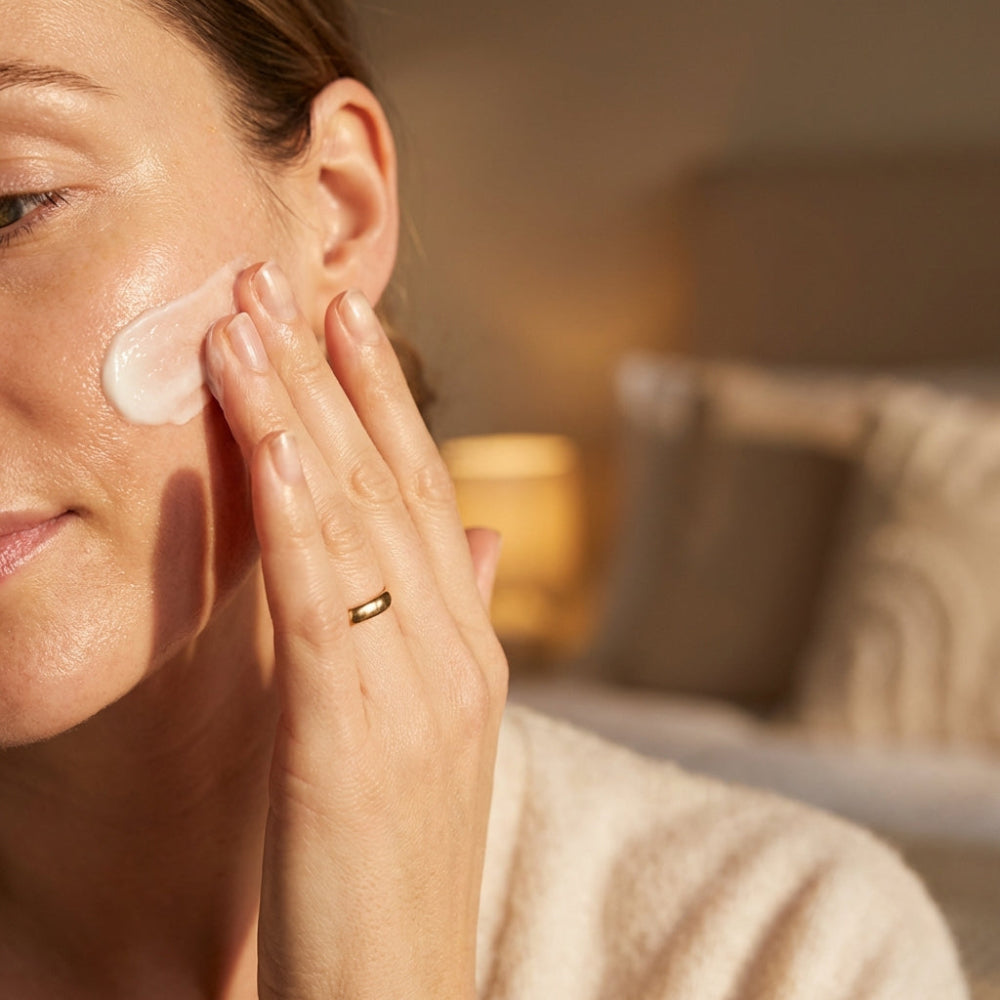 Woman applying night cream to her face