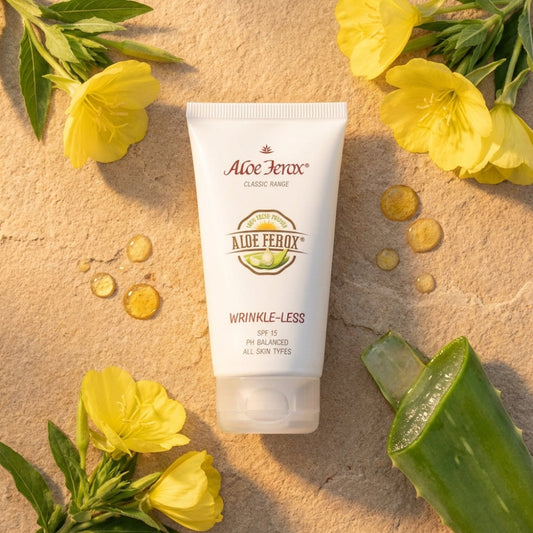 Aloe Ferox wrinkle-less cream tube with aloe vera leaves and yellow flowers on a beige background